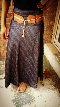 Women's lightly checkered skirt with elegant brown belt